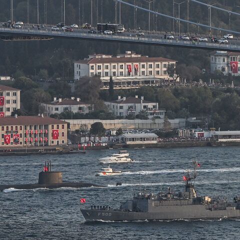 Turkish naval forces patrol vessel TCG F 500 and an unidentified submarine (back) sail during a military naval parade on the Bosphorus in Istanbul on Oct. 29, 2023.