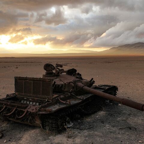 A destroyed Syrian army battle tank lies abandoned near the ancient ruins of Palmyra in central Syria on Feb. 7, 2025. 