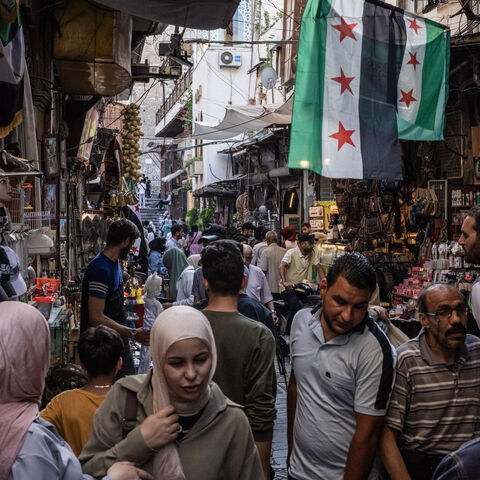 People shop in a market on June 17, 2025 in Damascus, Syria. 