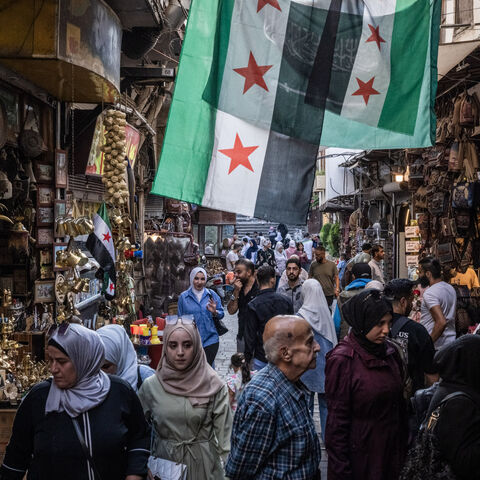 People shop in a market on June 17, 2025 in Damascus, Syria. 