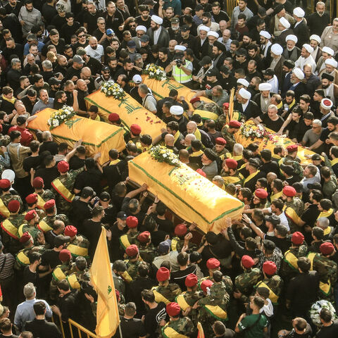 Supporters of Lebanon's Shiite militant group Hezbollah carry the coffins of militants killed in recent Israeli attacks during their funeral in the southern city of Nabatiyeh on November 2, 2025. Hundreds of people gathered in south Lebanon's Nabatiyeh on November 2, 2025 to mourn five Hezbollah members killed in recent Israeli attacks, an AFP correspondent said, as Israel warned of intensifying attacks against the Iran-backed group. On November 1, an Israeli strike killed four people in Kfar Rumman, Nabati