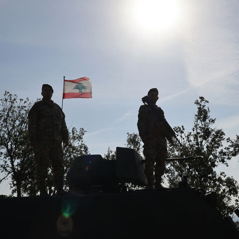 This photograph taken during a press tour organised by the Lebanese army shows Lebanese soldiers standing atop a military vehicle in Alma Al-Shaab, near the border with Israel in southern Lebanon, on November 28, 2025. It was the first guided tour the army gave journalists since a November 2024 ceasefire sought to end over a year of hostilities between Hezbollah and Israel. (Photo by Anwar AMRO / AFP via Getty Images)