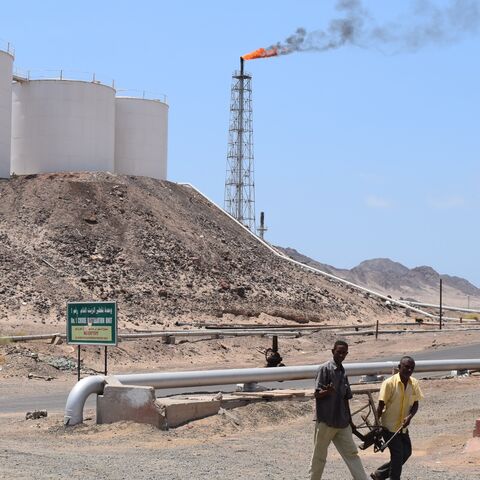 Yemeni employees walk at the Aden oil refinery company in Yemen's port city of Aden on Sept. 29, 2015.