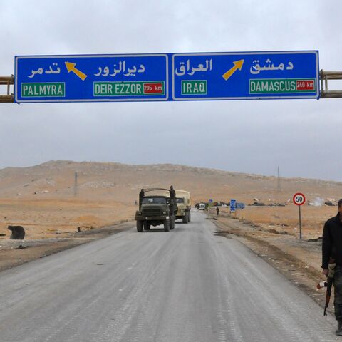 A picture taken on March 2, 2017, shows a sign displaying the routes to Palmyra-Deir Ezzor and Damascus-Iraq as Syrian regime fighters advance to retake the ancient city of Palmyra, from Islamic State (IS) group fighters. / AFP PHOTO / STRINGER (Photo credit should read STRINGER/AFP via Getty Images)