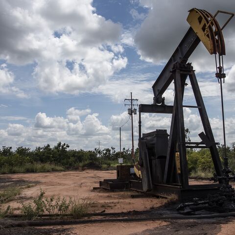 A pump jack stands near an oil spill at a facility in Venezuela.