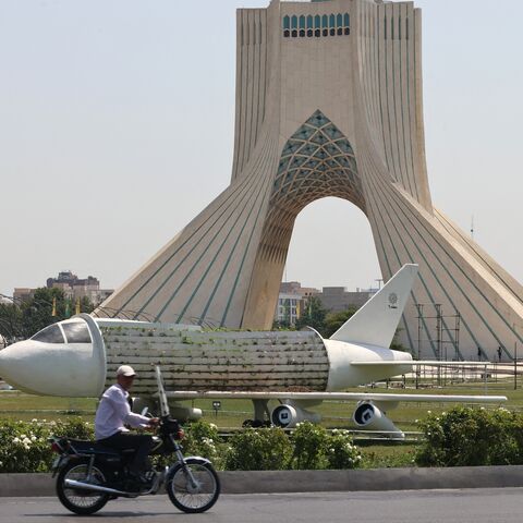An Iranian rides his motorcycle near Azadi Square in Tehran, on June 14, 2025. 