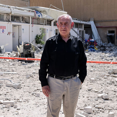 Israeli Prime Minister Benjamin Netanyahu stands amid debris outside the Soroka Hospital after it was hit by a missile fired from Iran, Beersheba, Israel, June 19, 2025.