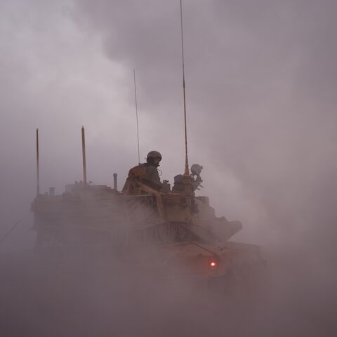 An Israeli soldier rides in the army Merkava main battle tank at a position in northern Israel along the border with southern Lebanon, Nov. 6, 2025, when Israel struck Hezbollah targets in southern Lebanon.