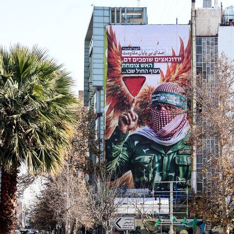 A large anti-Israeli banner portraying an image of a Palestinian fighter and the slogan in Persian and Hebrew, "Endless Voice of Resistance," is erected in Palestine Square in Tehran on Dec. 31, 2025, after Israel's Mossad spy agency issued a direct call urging Iranians to press on with protests. 