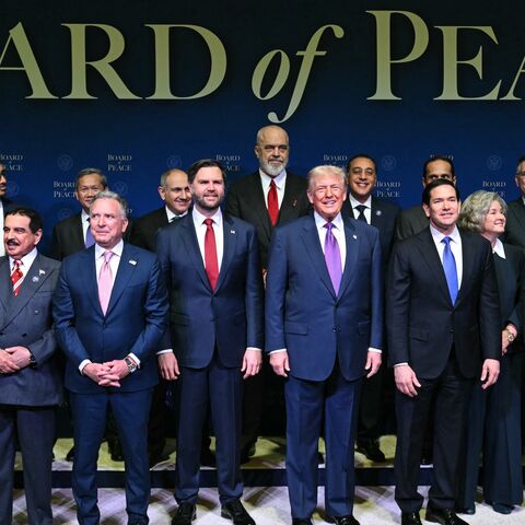 US President Donald Trump (C), flanked by US Vice President JD Vance (L) and US Secretary of State Marco Rubio (R), joins leaders for a group photo during the inaugural meeting of the Board of Peace at the US Institute of Peace in Washington, on Feb. 19, 2026.