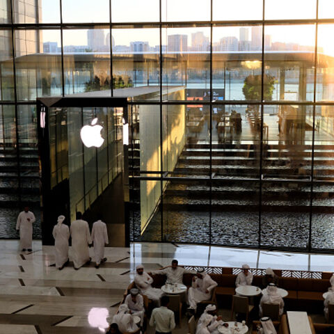 People sit in a cafe outside the Apple Store in Dubai on May 8, 2025. (Photo by Giuseppe CACACE / AFP) (Photo by GIUSEPPE CACACE/AFP via Getty Images)