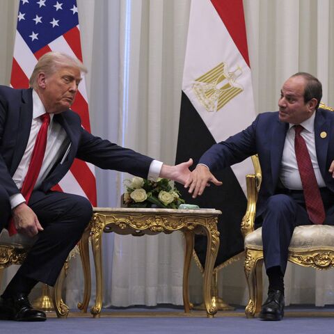 US President Donald Trump and President of Egypt Abdel Fattah El-Sisi clasp hands as they speak to the press before their meeting on Oct. 13, 2025, in Sharm el-Sheikh, Egypt. 