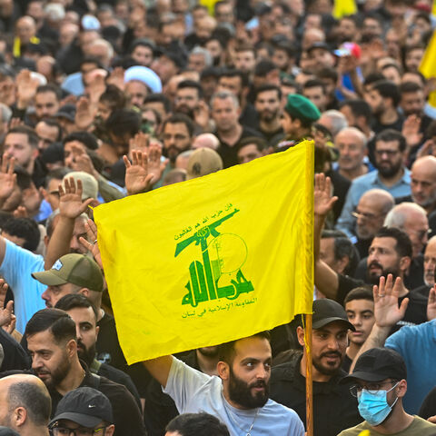 Mourners wave Hezbollah flags during the funeral ceremony of top Hezbollah chief Haytham Ali Tabatabai and other members killed in an Israeli strike in Beirut's southern suburbs on November 24, 2025. 