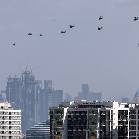 United Arab Emirates army helicopters fly from the Burj al Arab hotel (R) toward Burj Khalifa, Dubai, Jan. 16, 2026.