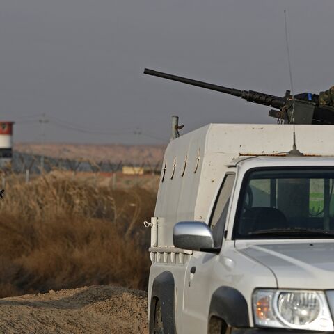 Members of the Popular Mobilization Units stand guard along the Iraqi-Syrian border in Al-Qaim, west of Iraq, on Jan. 23, 2026. 