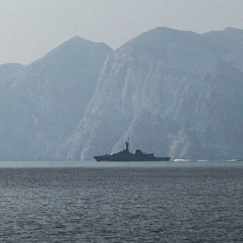 A navy vessel is seen sailing in the Strait of Hormuz, a vital waterway through which much of the world's oil and gas passes, on March 1, 2026. 