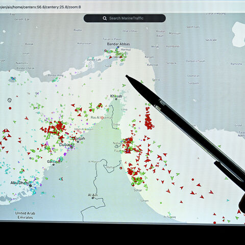 A person points at a page on the Marinetraffic website that shows commercial boats traffic on the edge of the Strait of Hormuz near the Iranian coast, in Paris on March 4, 2026. (Photo by JULIEN DE ROSA / AFP via Getty Images)