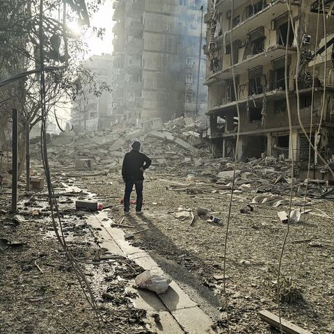 A man looks at the site of overnight Israeli airstrikes in the southern suburbs of Beirut on March 12, 2026. 