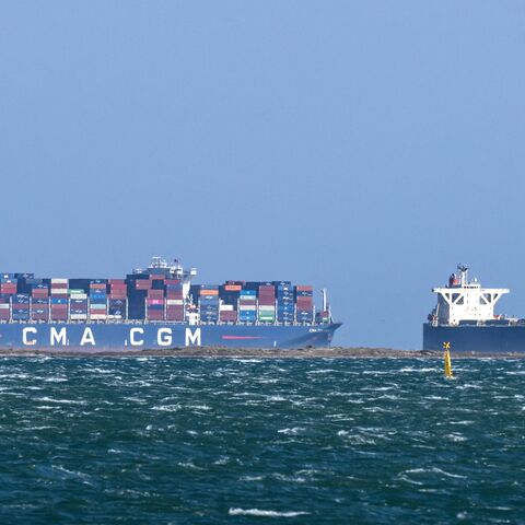 This photograph shows the Malta-flagged container ship CMA CGM "pollon Valletta and the Panamean-flagged Wood Chips carrier Green Sapphire in the sea in Fos-sur-Mer, southern France, on March 25, 2026.