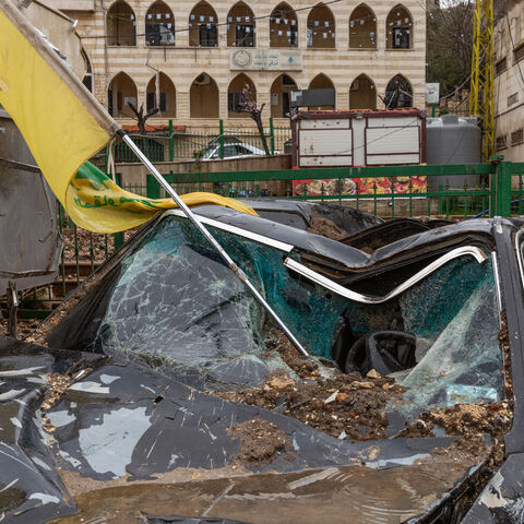 A Hezbollah flag is seen in a destroyed car after an Israeli airstrike in Nabi Chit (Al-Nabi Shayth), Lebanon, on March 26, 2026. In the first week of March, the Israeli army carried out an unsuccessful nighttime commando operation there to recover the remains of Ron Arad, a pilot missing since 1986, triggering airstrikes and destruction in the area that forced residents to flee their homes. (Photo by Fabio Bucciarelli / Middle East Images / AFP via Getty Images)