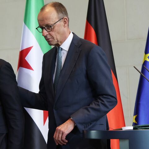 German Chancellor Friedrich Merz (R) and Syrian President Ahmed al-Sharaa depart after speaking to the media following talks at the Chancellery on March 30, 2026, in Berlin, Germany.