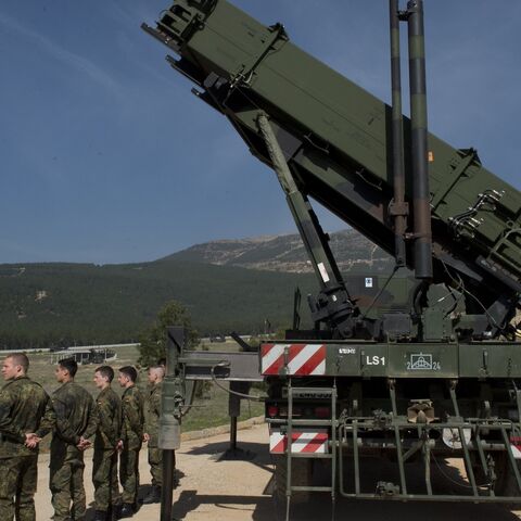 German soldiers stand to attention in front of a German Patriot missile launcher at the Gazi barracks in Kahramanmaras, southern Turkey on March 25, 2014. 