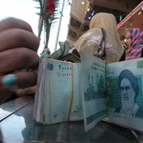 An Iraqi money dealer counts Iranian rial banknotes bearing a portrait of the late founder of the Islamic Republic of Iran, Ayatollah Ruhollah Khomeini, at an exchange office in Baghdad on Feb. 3, 2012. 