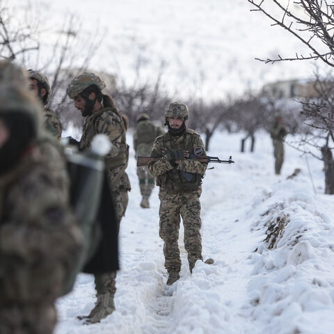Syrian soldiers stand in the snow in the country's mountainous Qalamoun region, near the border with Lebanon, during a patrol to secure the frontier and prevent smuggling operations on January 1, 2026. (Photo by Bakr ALkasem / AFP via Getty Images)