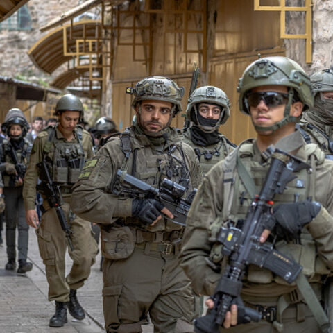 Israeli soldiers patrol a street in Hebron's Old City in the occupied West Bank on January 23, 2026, deployed as settlers entered the area under army protection. (Photo by Mosab Shawer / Middle East Images / AFP via Getty Images)