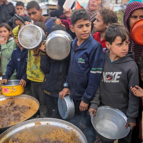 Children and families gather to receive free meals shortly before Iftar during the holy month of Ramadan at a displacement camp in central Gaza City, on Feb. 27, 2026.