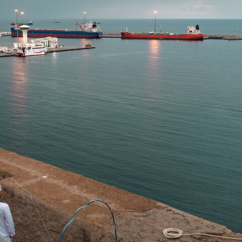 MUSCAT, OMAN - MARCH 25: Locals take photos of two bulk carriers anchored at Muscat Anchorage on March 25, 2026 in Muscat, Oman. Maritime traffic through the Strait of Hormuz, which conveys about 20% of the world's oil and gas, has mostly come to a halt after the joint U.S.-Israeli war with Iran that began on February 28. Iran, in a defiant reply to a ceasefire proposal from the United States, has claimed that sovereignty over the Strait of Hormuz "is its natural and legal right." Under international law, t