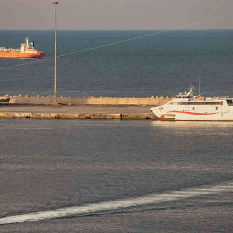 A police speed boat patrols the port as oil tankers and high speed crafts sit anchored at Muscat Anchorage near the Strait of Hormuz on March 30, 2026 in Muscat, Oman.