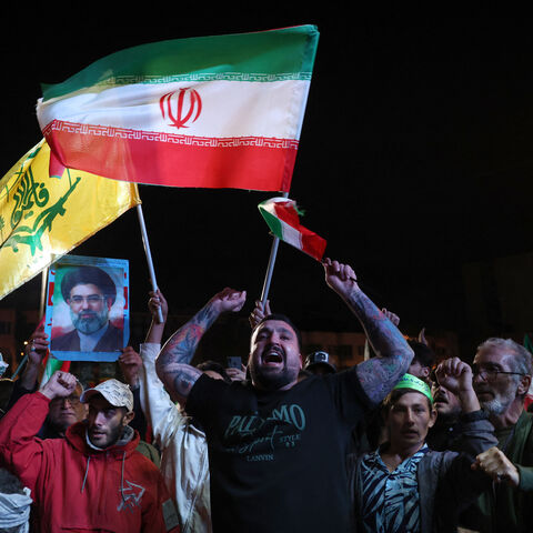 TOPSHOT - Iranians react after a ceasefire announcement at the Enqelab square, in Tehran, on April 8 2026. The United States and Iran agreed to a two-week ceasefire Tuesday barely an hour before US President Donald Trump's deadline to obliterate the rival country was set to expire, with Tehran to temporarily reopen the vital Strait of Hormuz. (Photo by AFP via Getty Images) /