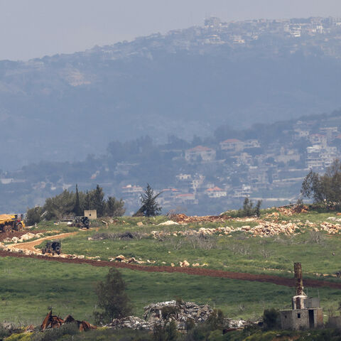 Israeli military vehicles drive along a road in southern Lebanon, near the Israeli border on April 8, 2026. Israel's Defence Minister Israel Katz said the military had carried out a surprise attack on April 8 targeting hundreds of Hezbollah members across Lebanon. (Photo by Jalaa MAREY / AFP via Getty Images) /