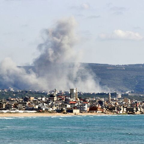 This photograph taken from the southern Lebanese area of Tyre shows smoke as it rises from the site of an Israeli airstrike that targeted the village of Qlaileh on April 13, 2026.
