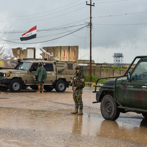 Members of Iraq's security forces stand guard on the the al-Rabia border crossing with Syria on April 20, 2026. 