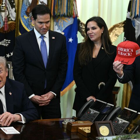 US Ambassador to Lebanon Michel Issa (R) holds a signed "Make America Great Again" hat while (L-R) US Secretary of State Marco Rubio and Lebanon Ambassador to the US Nada Hamadeh Moawad listen to US President Donald Trump speak during a meeting with Lebanon Ambassador to the US and Israel Ambassador to the US, at the White House in Washington, DC on April 23, 2026. US President Donald Trump met Lebanese and Israeli envoys at a new round of peace talks Thursday, with Beirut seeking a one-month extension of a