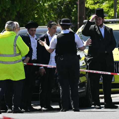 Local residents look on from outside a cordoned off area in the Golders Green neighborhood of north London on April 29, 2026, following the stabbing to two people nearby.