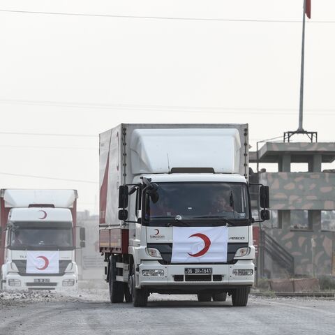 Turkish Red Crescent's cars and trucks cross the Turkish border as they leave the Syrian city of Tel Abyad on Oct. 19, 2019, in Akcakale, Turkey. 