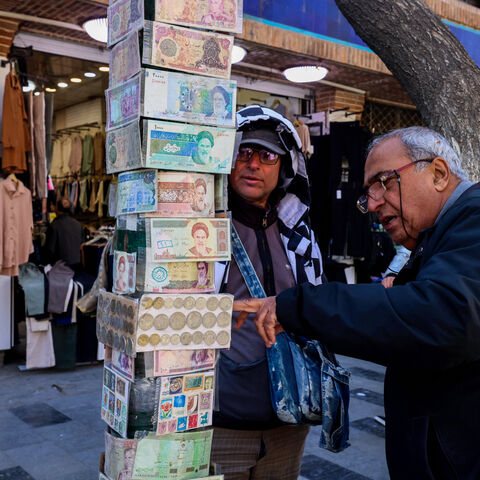 A man checks old banknotes in the Grand Bazaar in Tehran on March 3, 2025. 