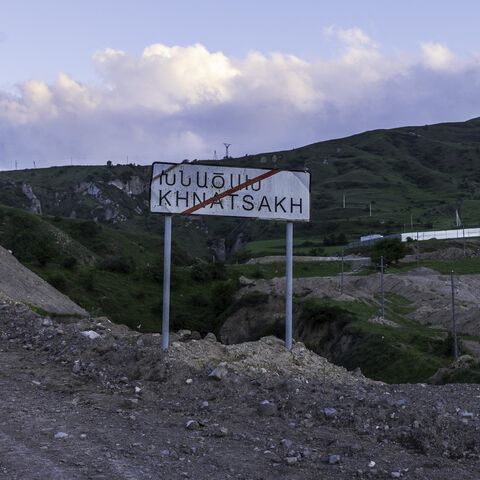 A roadside sign marks the entrance to Khnatsakh on May 16, 2025, a border village in Armenia's Syunik Province that has become a frontline community amid rising tensions with Azerbaijan. 