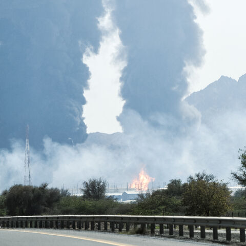 Smoke and flames rise from an energy installation in the Gulf emirate of Fujairah on March 14, 2026. Smoke could be seen rising from the direction of a major UAE energy installation on March 14, in what appeared to be the latest strike targeting the Gulf's petroleum facilities hours after the US struck Iran's Kharg Island. (Photo by AFP via Getty Images) /