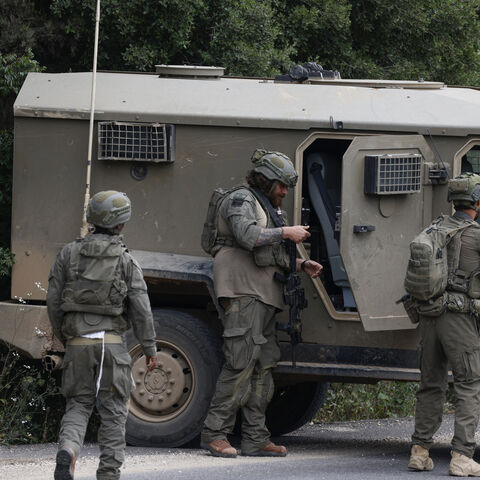 Israeli soldiers react after taking cover near the Israel-Lebanon border following a Hezbollah drone attack that hit the northern border on May 19, 2026. The Israeli military on May 19 warned residents of 12 towns and villages in southern Lebanon to immediately evacuate ahead of expected attacks against Hezbollah, the latest despite a ceasefire. (Photo by Jalaa MAREY / AFP via Getty Images)