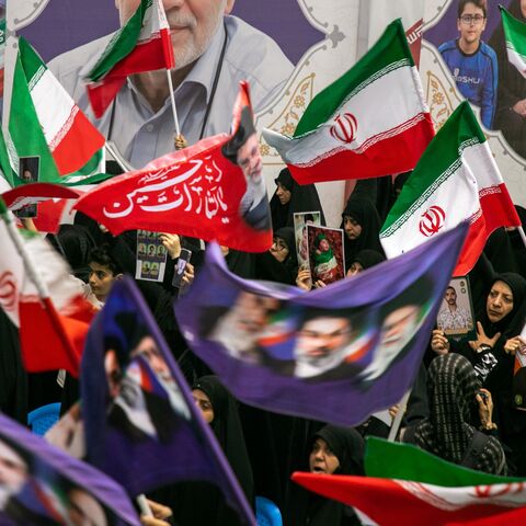 People hold portraits of the dead at the Imam Khomeini Mosalla Mosque to commemorate those killed in the current US-Israeli war as well as previous wars on May 24, 2026, in Tehran, Iran.