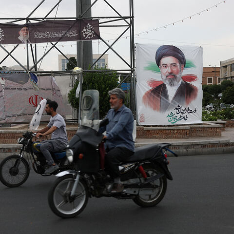 People ride near a banner with an image of Iran's Supreme Leader, Mojtaba Khamenei, on a street in Tehran, Iran June 7, 2026. Majid Asgaripour/WANA (West Asia News Agency) via REUTERS