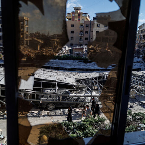People walk past rubble at the site of an Israeli strike following a deal between the U.S. and Iran in Tyre, southern Lebanon, June 16, 2026. REUTERS/Zohra Bensemra