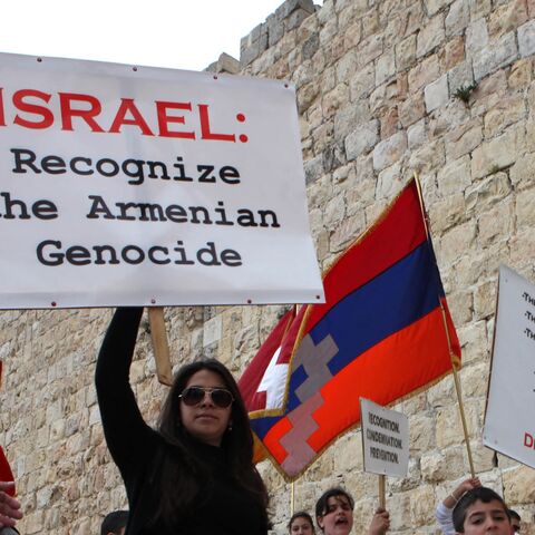 Members of the Jerusalem Armenian community hold placards as they march during commemorations for the 94th anniversary of mass killings of their kin under the Ottoman Empire, Jerusalem's Old City, April 24, 2009.