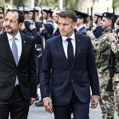 Cyprus' President Nikos Christodoulides (2nd L) and his French counterpart Emmanuel Macron (C) review the honor guard at the Presidential Palace in Nicosia on April 23, 2026, ahead of a meeting on the sidelines of a European summit. 