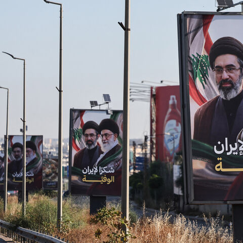 Cars drive past billboards showing Iran's new Supreme Leader Ayatollah Mojtaba Khamenei (L) and his late father Ali Khamenei (R), with the slogan "Thank you, loyal Iran," erected along the highway leading to Rafik Hariri International Airport, Beirut, Lebanon, June 22, 2026.