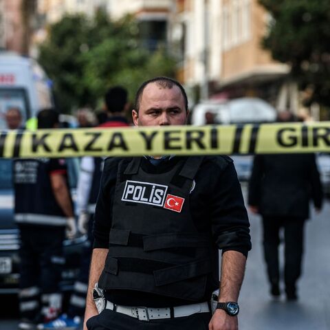 A Turkish police officers patrols at the scene of a motor-bike bomb explosion, next to a police station on Oct. 6, 2016, in Istanbul. 